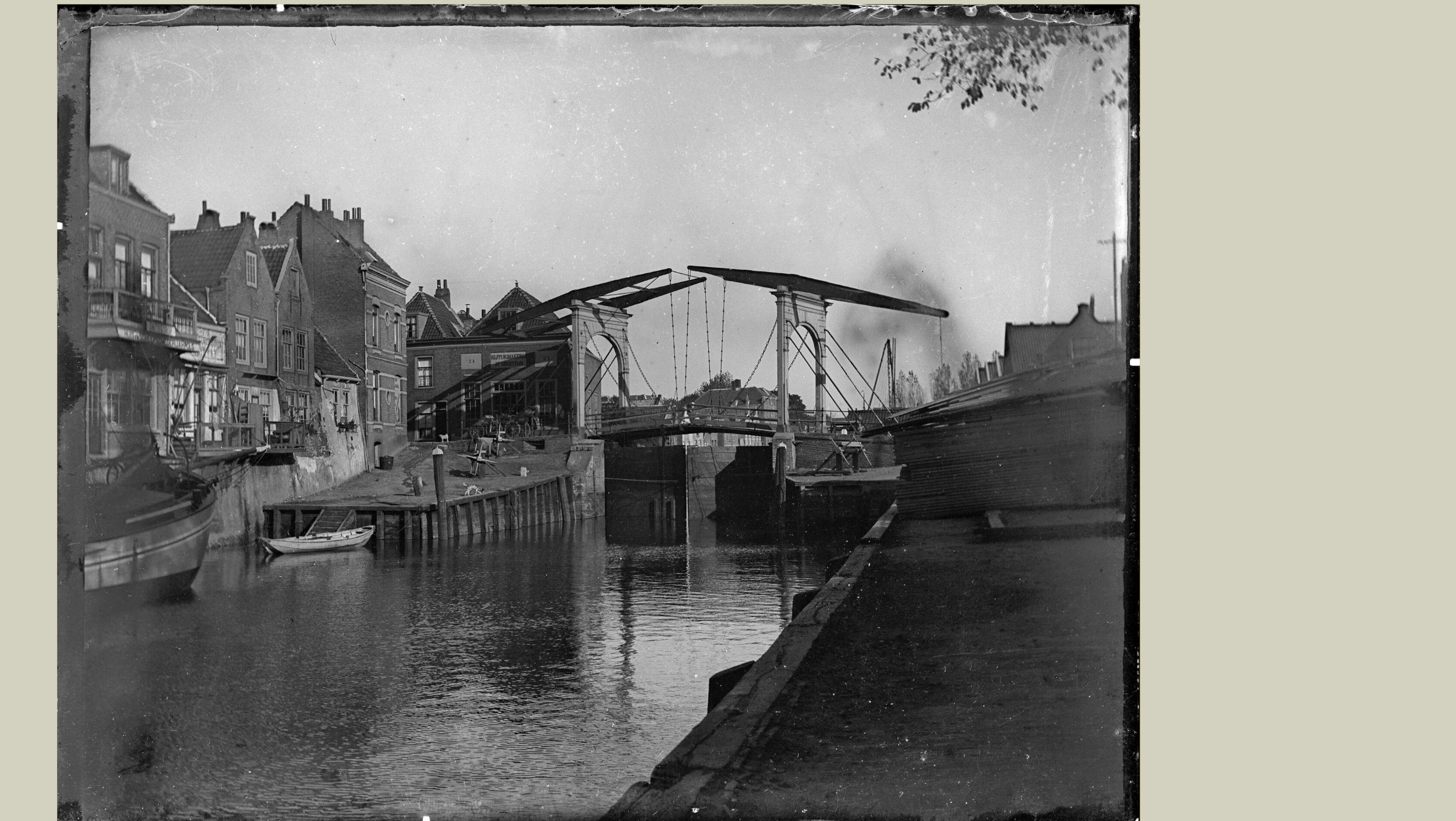 De dubbele ophaalbrug is in 1906 vervangen door een ijzeren hefbrug (zie het schilderij van Klinkenberg). Foto Beeldbank ca. 1900. Verbinding tussen Kalkhaven en Spuihaven vanaf Achterhakkers richting Zuidersluisbrug en Prinsenstraat met zicht op achterkant huizen Kleine Kalkstraat